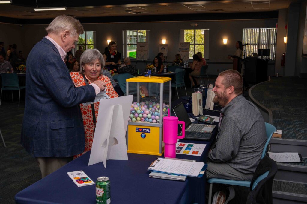 Donors open a container from a gumball machine to see what prize they've won.