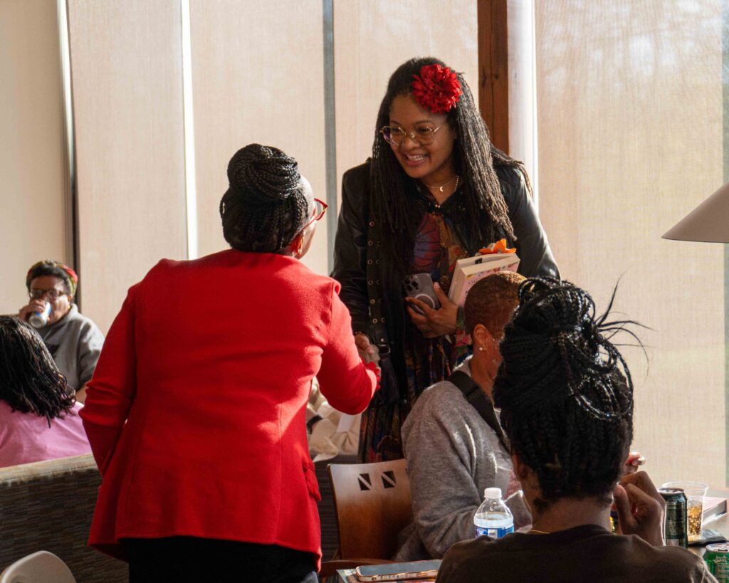 Author Dolan Perkins-Valdez greets an event attendee.